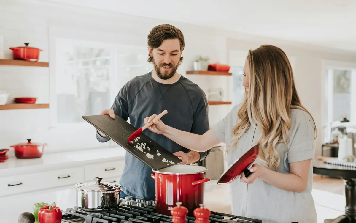 Couple cooking together in a bright kitchen