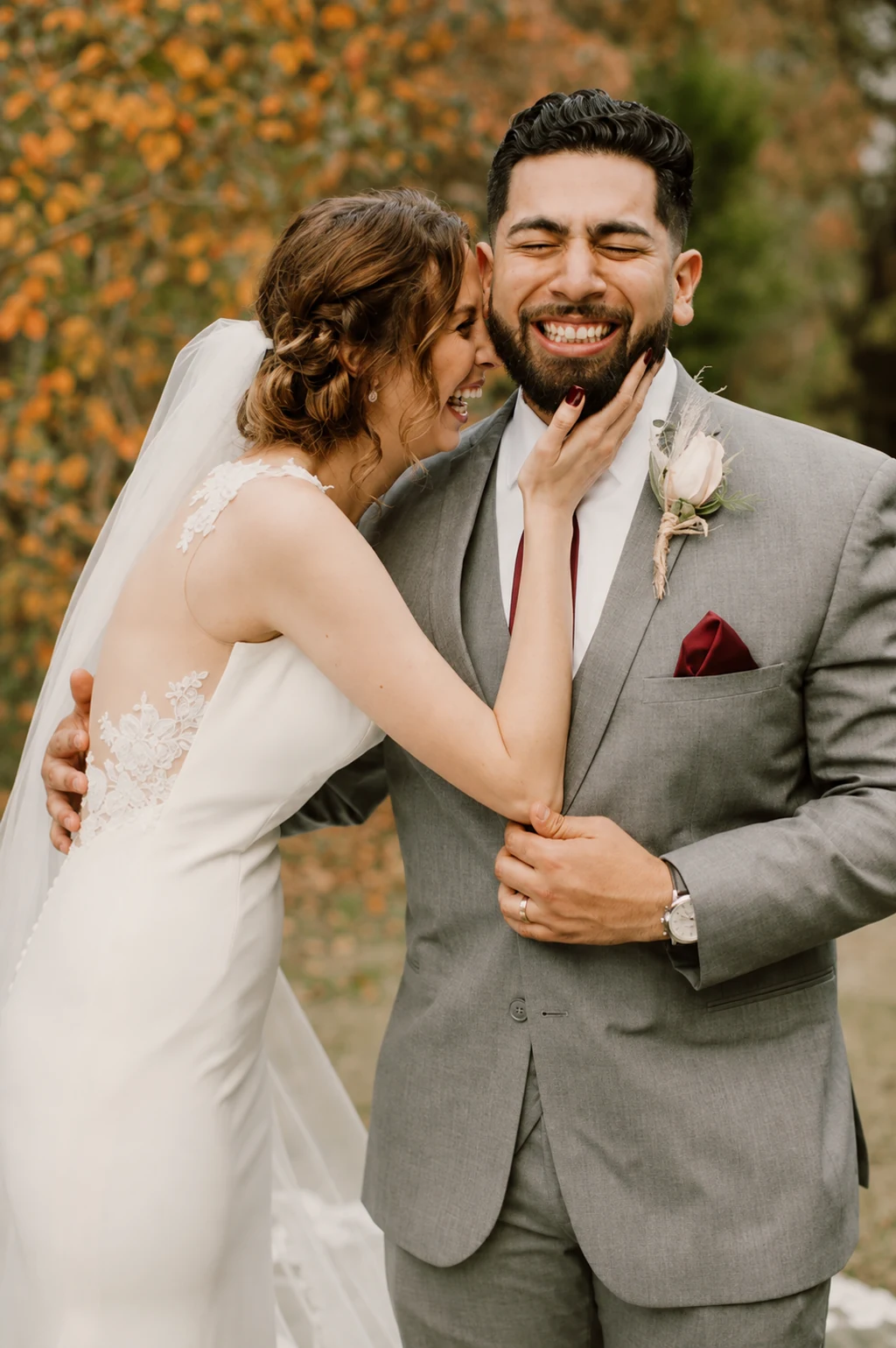 A couple laughing together on their wedding day